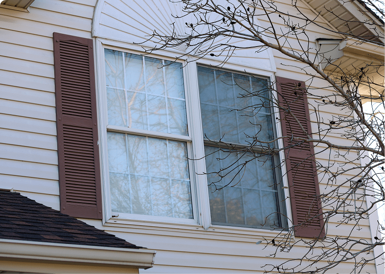 House window with brown shutters