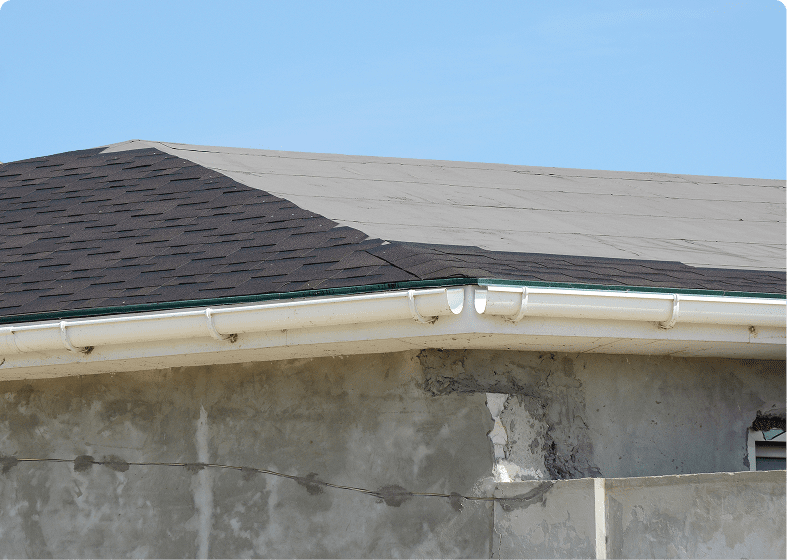 House roof with cracked wall beneath
